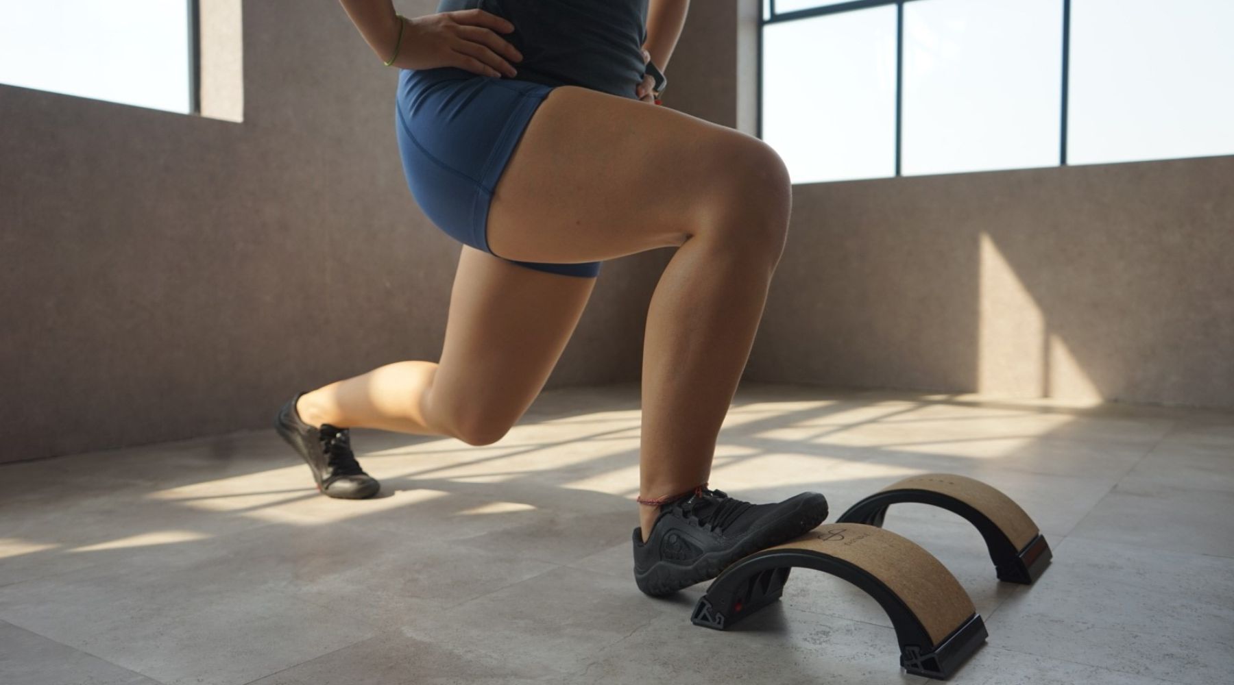 Woman using the Yoback for squats
